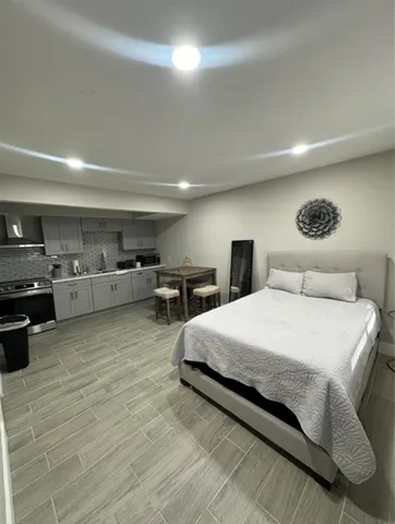 a spacious bedroom with a bed and furniture