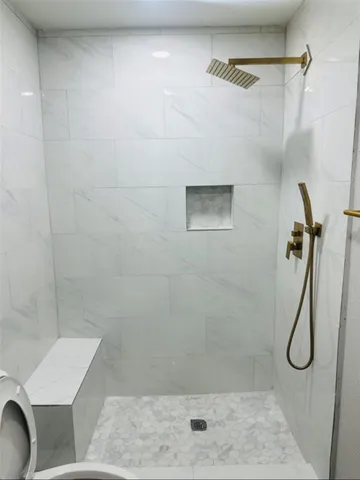 a bathroom with a shower and toilet