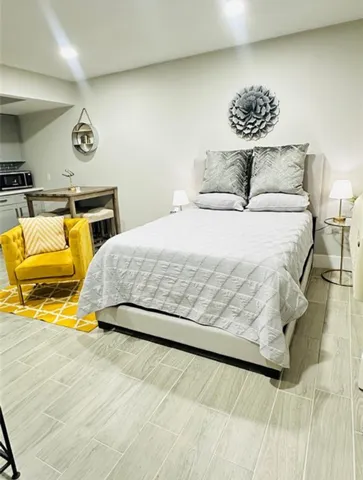 a bedroom with a bed and wall painting