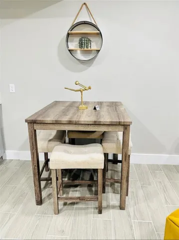 a view of a dining room with furniture and a mirror