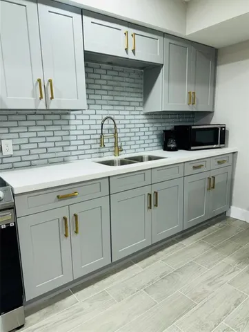 a kitchen with stainless steel appliances granite countertop white cabinets a sink and dishwasher