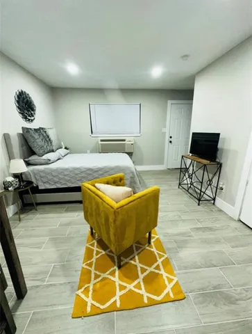 a bedroom with a bed and chair