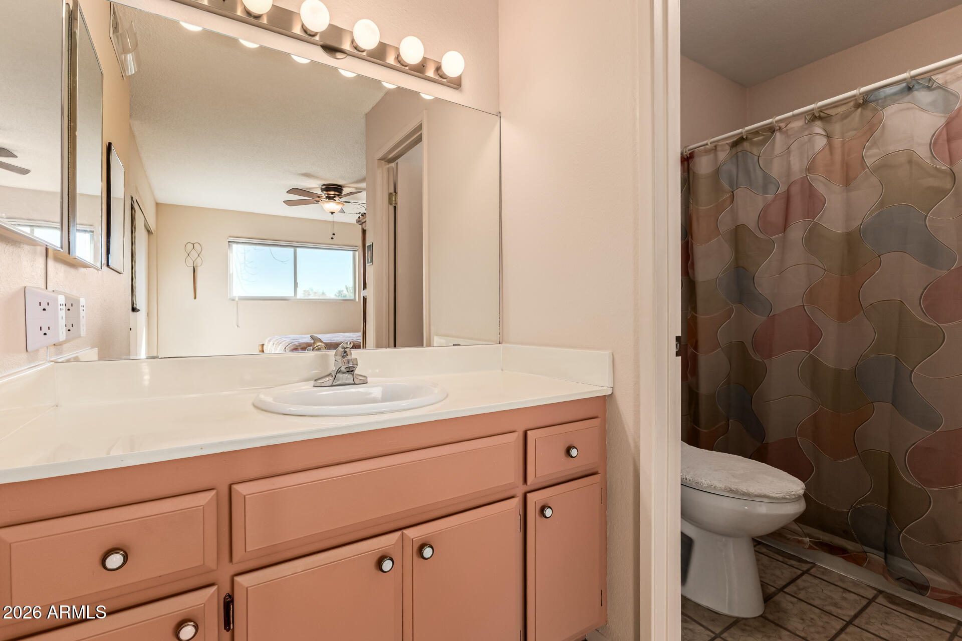 5525 East Thomas Road, Unit O8 Phoenix, AZ 85018 - Photo 17 of 32 a bathroom with a granite countertop sink a toilet and a mirror