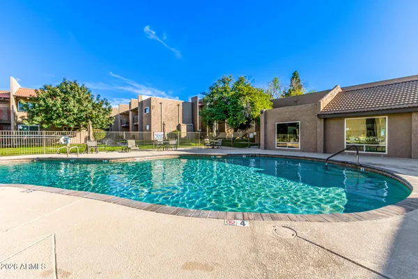 a view of swimming pool with outdoor seating