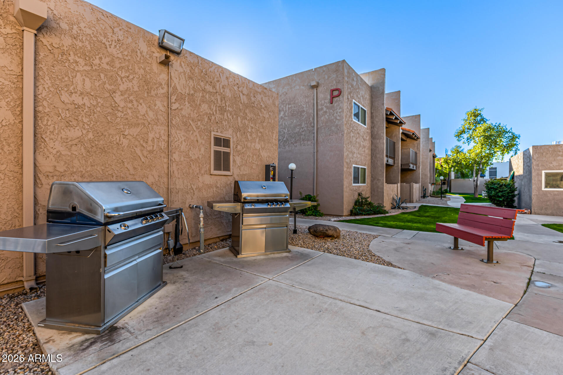 5525 East Thomas Road, Unit O8 Phoenix, AZ 85018 - Photo 31 of 32 a backyard of a house with barbeque oven and a fire pit