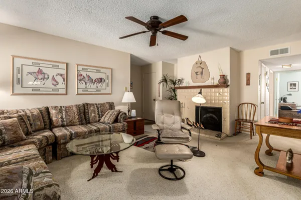 a view of a livingroom with furniture and a fireplace
