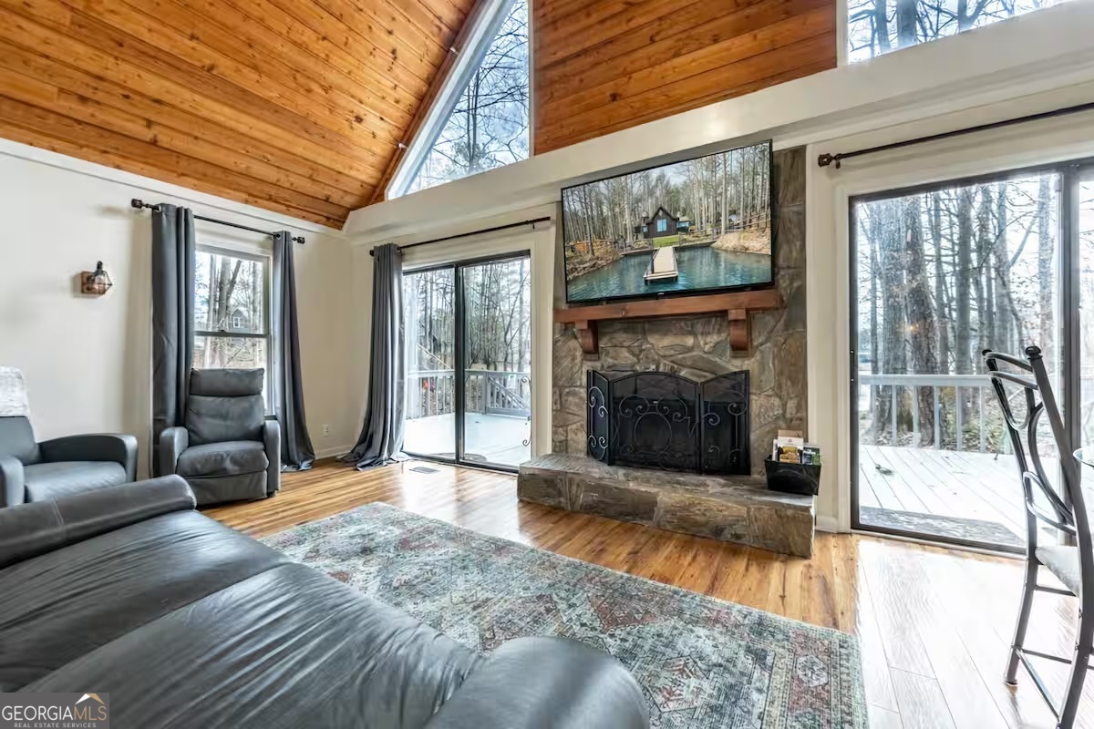 68 Franklin Road Eatonton, GA 31024 - Photo 10 of 28 a view of a livingroom with a fireplace and large windows