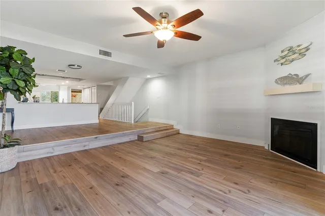 a living room with furniture kitchen area and a couch