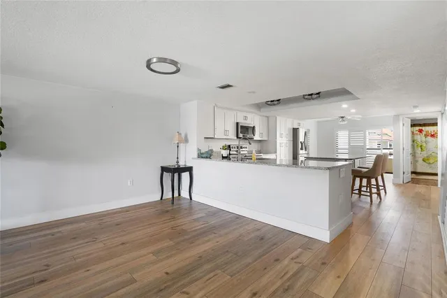 a large kitchen with kitchen island granite countertop lots of counter top space