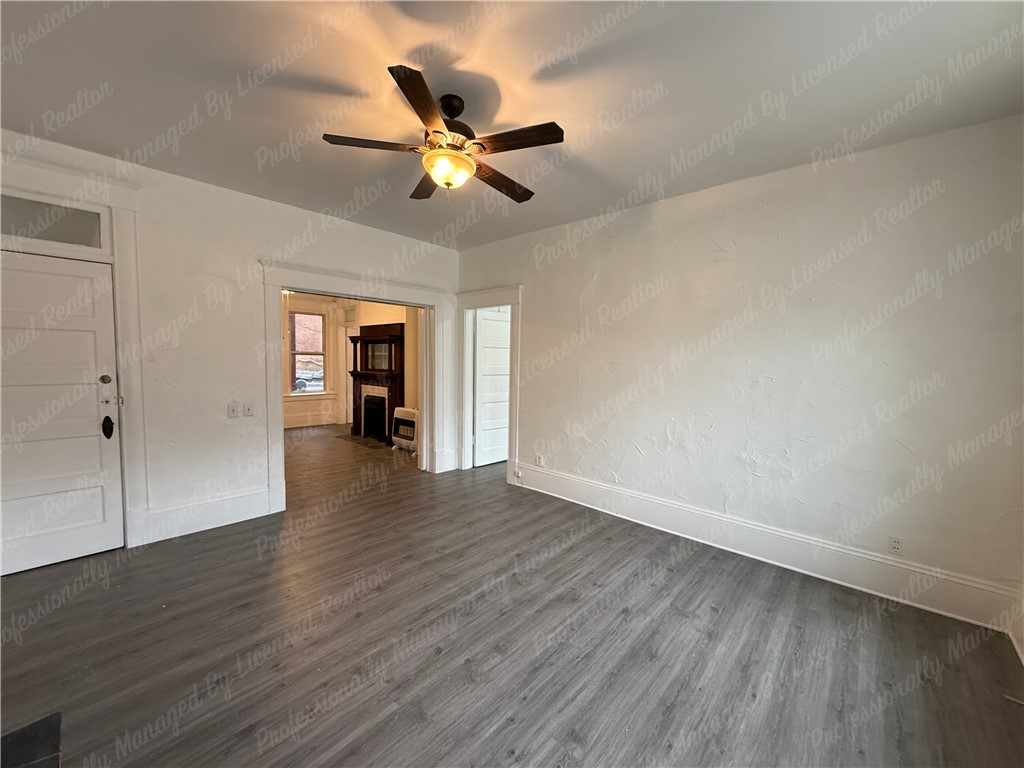 44 West High Street, Unit B Springfield, OH 45502 - Photo 7 of 31 This inviting space features durable flooring and classic architectural details, offering comfortable living.