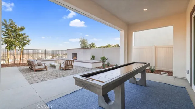 a living room with furniture a rug and a potted plant