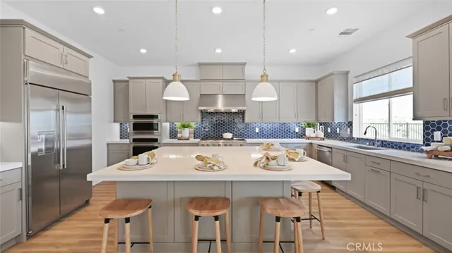 a large kitchen with a table and chairs