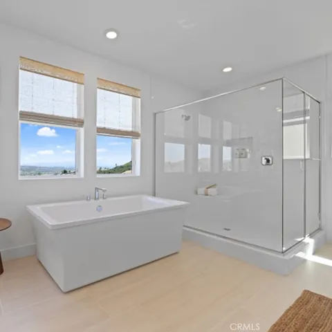 a spacious bathroom with a bathtub and a shower