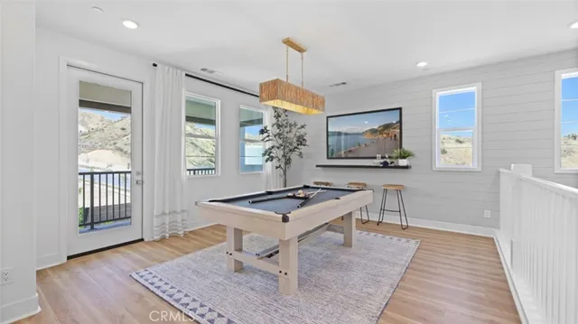 a living room with furniture a desk and chair with windows