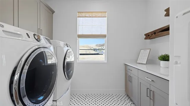 a utility room with sink dryer and washer