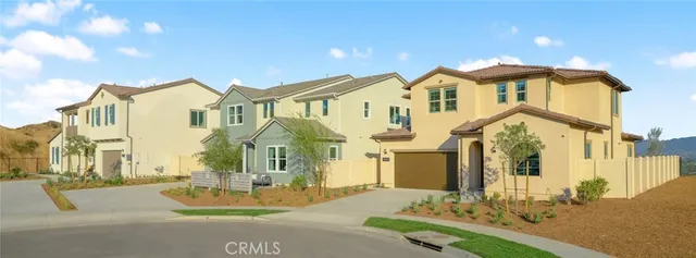 a front view of a house with a garden and yard