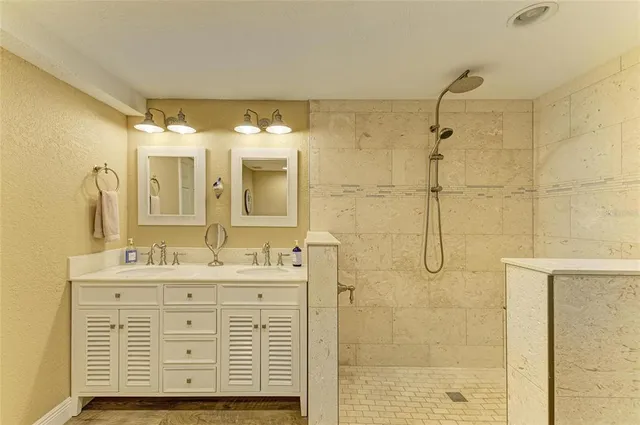 a bathroom with a double vanity sink a mirror and shower