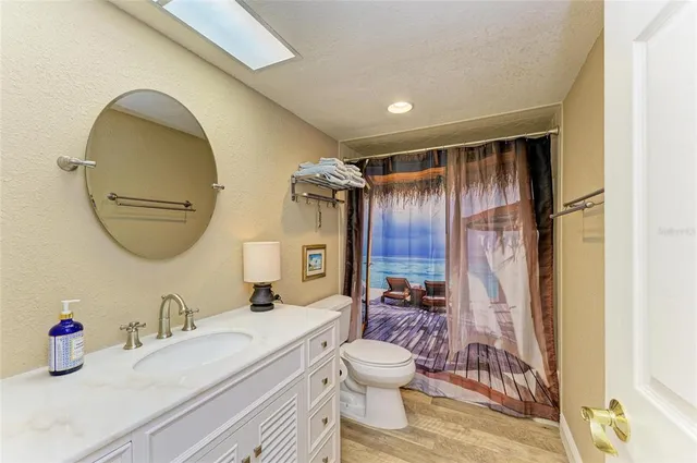 a bathroom with a sink mirror vanity and toilet