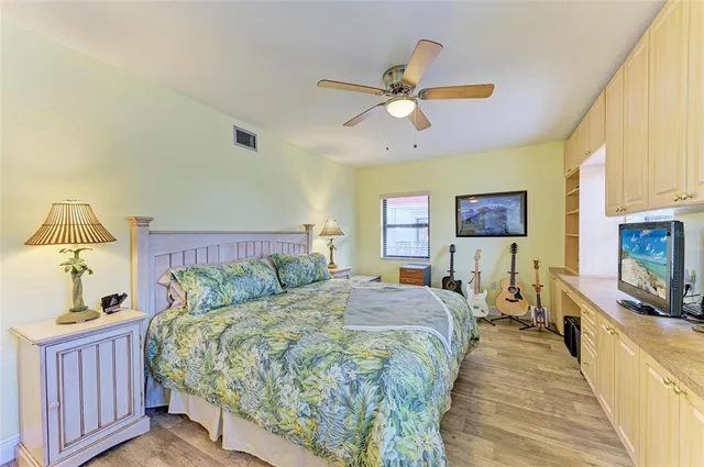 a bed room with a bed and a flat screen tv