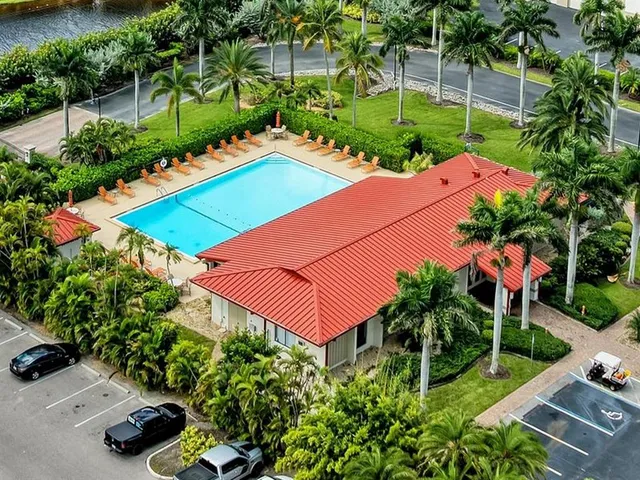 an aerial view of a house with a yard and swimming pool