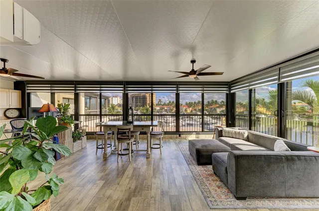 a living room with furniture and a large window with wooden floor