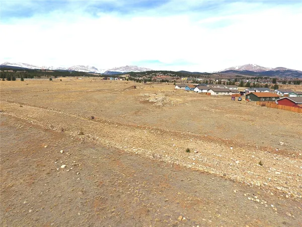 a view of a lake with houses in the back
