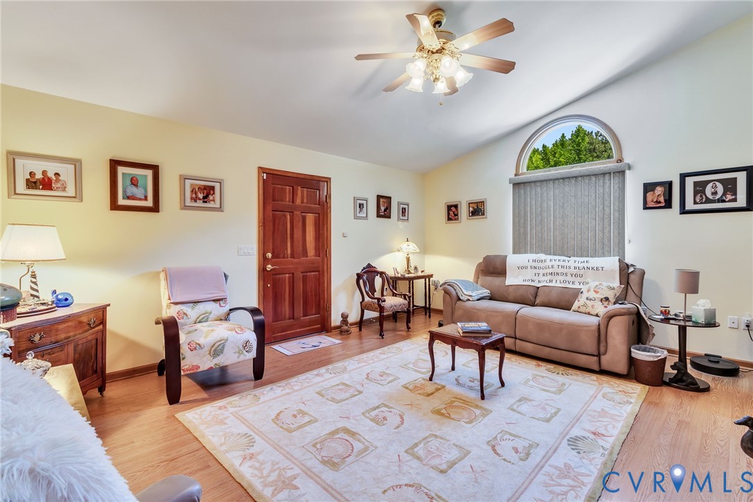 4400 Hacks Neck Road Heathsville, VA 22473 - Photo 30 of 78 a living room with furniture a rug and a chandelier