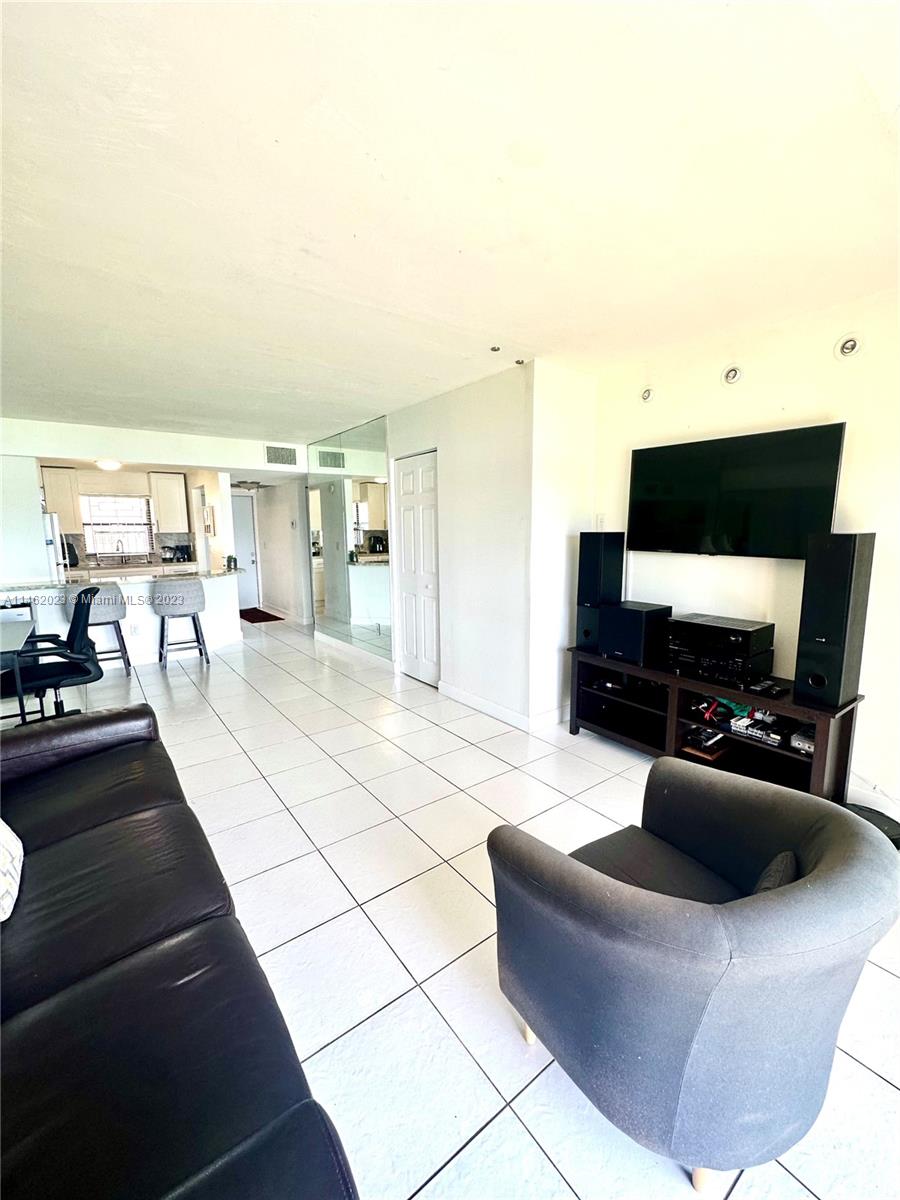 2580 West 67th Place, Unit 1011 Hialeah, FL 33016 - Photo 13 of 23 a living room with furniture and a flat screen tv