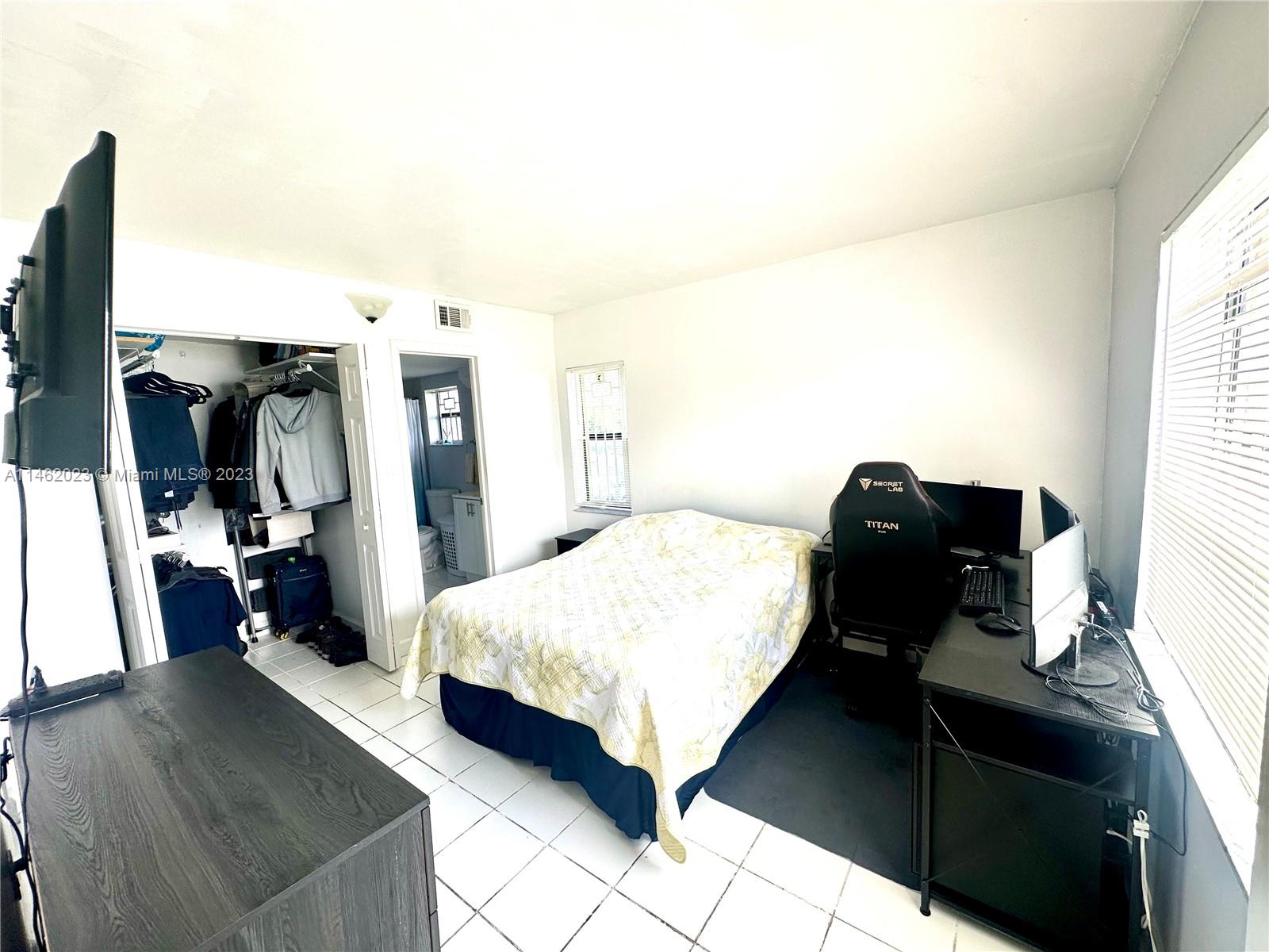 2580 West 67th Place, Unit 1011 Hialeah, FL 33016 - Photo 15 of 23 a bedroom with a bed and wooden floor