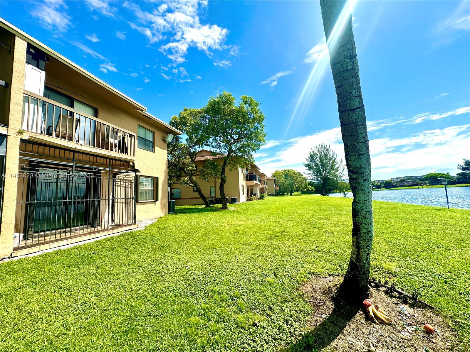 2580 West 67th Place, Unit 1011 Hialeah, FL 33016 - Photo 2 of 23 a view of an house with backyard porch and garden