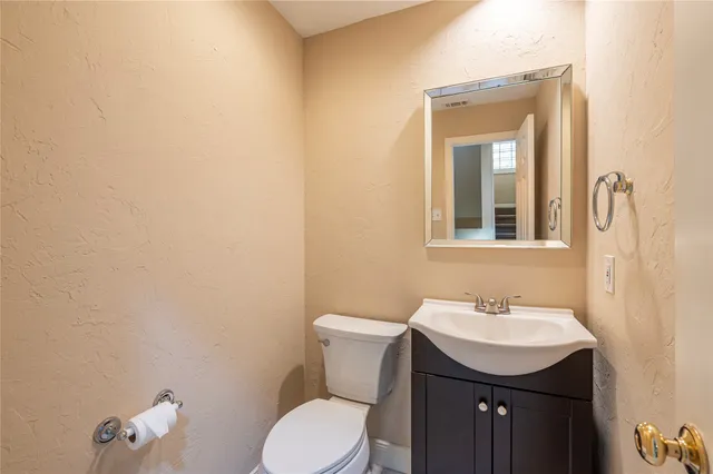 a bathroom with a sink a toilet and mirror