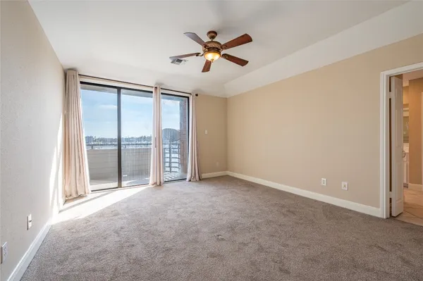 a view of an empty room with a ceiling fan
