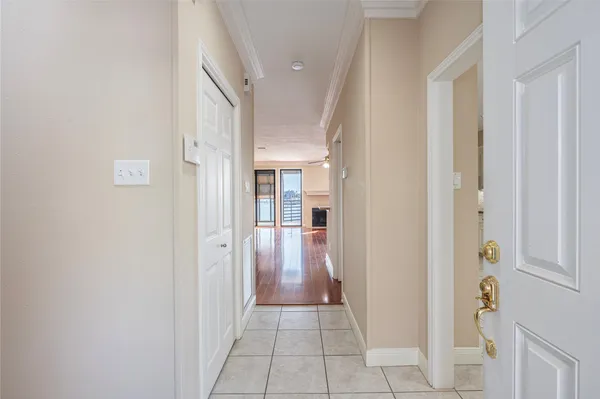 a view of a hallway with wooden shelves