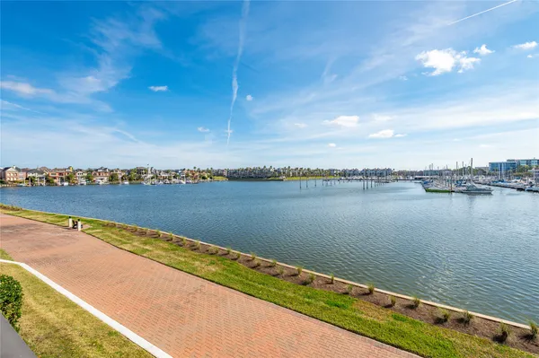 a view of a lake with houses in the back