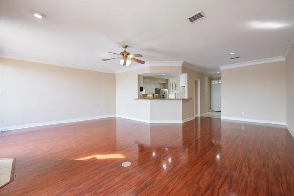 a view of empty room with wooden floor