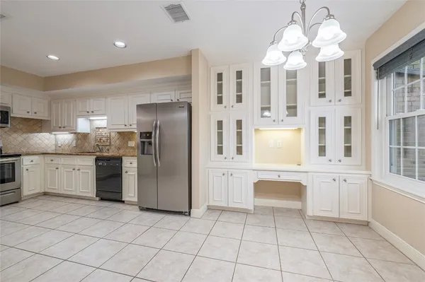 a kitchen with cabinets and stainless steel appliances