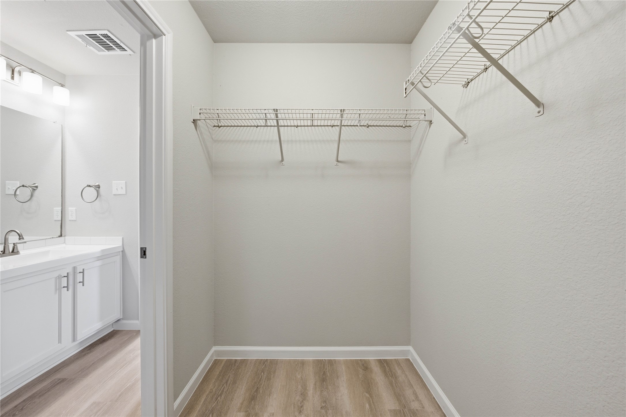 6917 Panda Royle Drive Del Valle, TX 78617 - Photo 15 of 23 Functional wire shelving optimizes storage within this well-appointed walk-in closet.