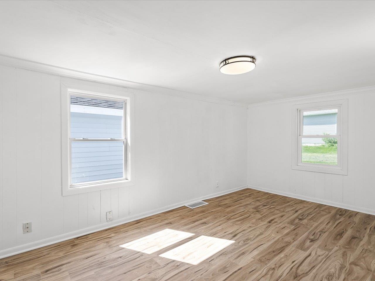 140 East Walnut Street Cedarville, IL 61032 - Photo 1 of 37 a view of empty room with wooden floor and fan