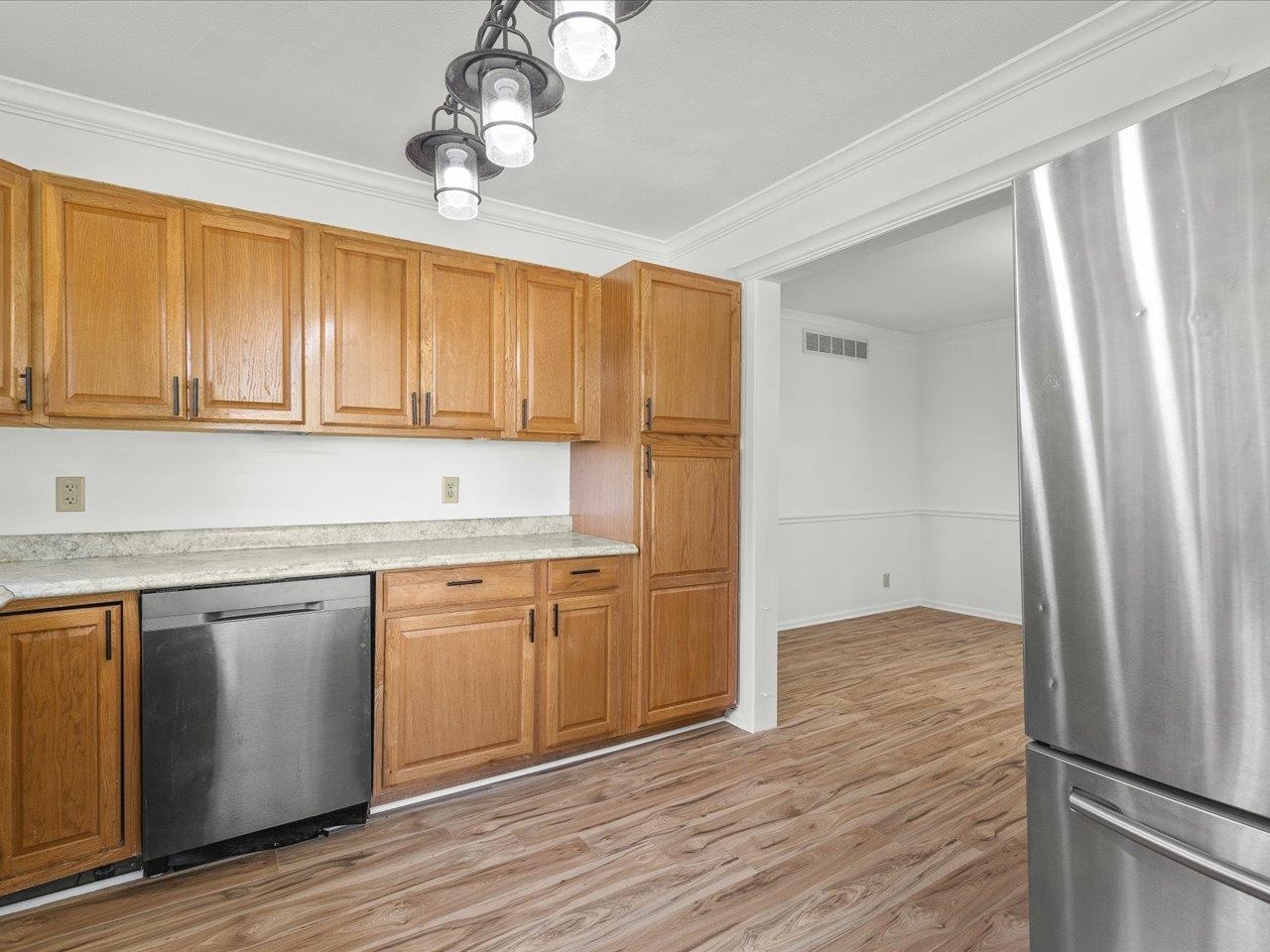 140 East Walnut Street Cedarville, IL 61032 - Photo 22 of 37 a kitchen with stainless steel appliances granite countertop a refrigerator a sink dishwasher a stove and white countertops with wooden floor