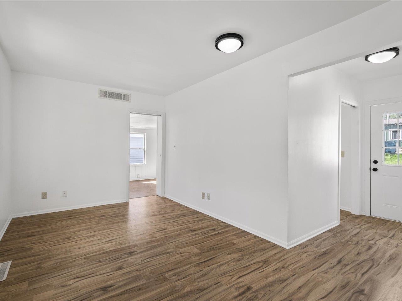 140 East Walnut Street Cedarville, IL 61032 - Photo 24 of 37 a view of an empty room with wooden floor and a window