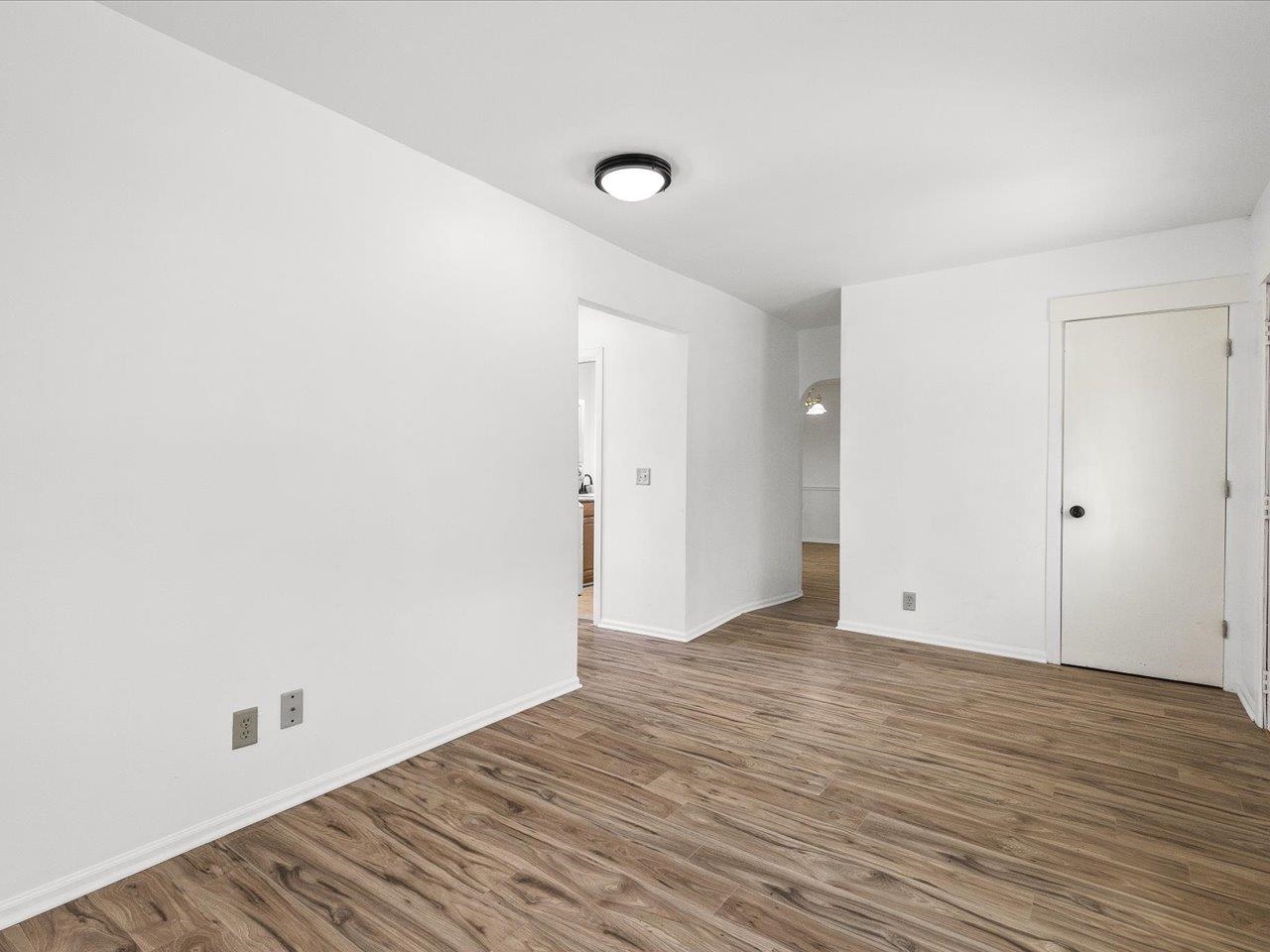 140 East Walnut Street Cedarville, IL 61032 - Photo 27 of 37 a view of an empty room with wooden floor and a window