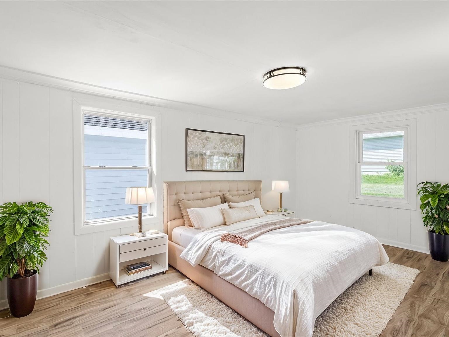140 East Walnut Street Cedarville, IL 61032 - Photo 28 of 37 a bedroom with a bed and a potted plant