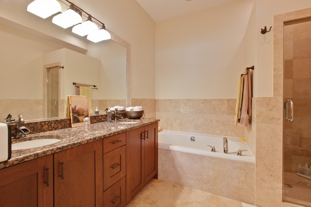 690 Lyster Road Highwood, IL 60040 - Photo 13 of 25 a bathroom with a granite countertop sink a large mirror and a bathtub