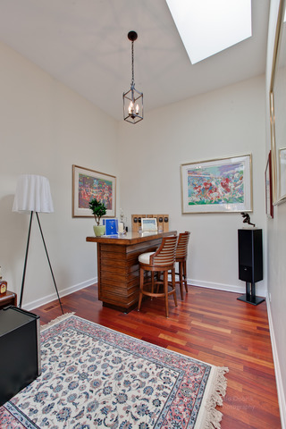 690 Lyster Road Highwood, IL 60040 - Photo 15 of 25 a living room with a dining table a rug and a chandelier