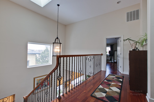 690 Lyster Road Highwood, IL 60040 - Photo 16 of 25 a view of staircase with railing and a chandelier