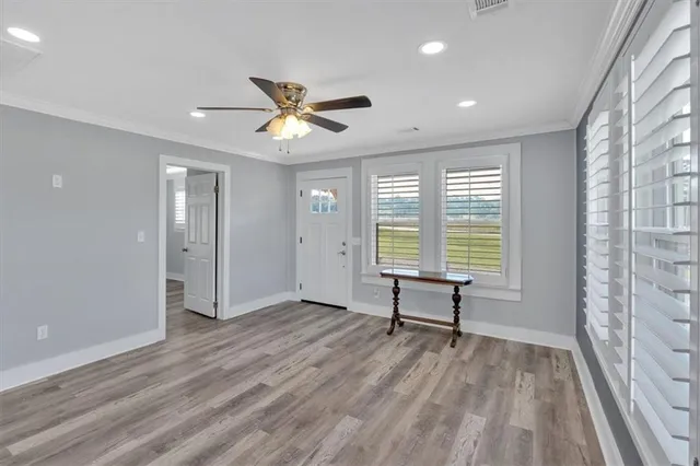 a view of a room with a window and wooden floor