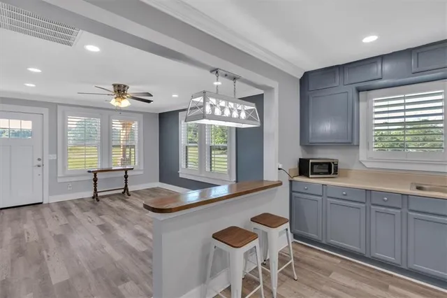 a kitchen with granite countertop white cabinets and window