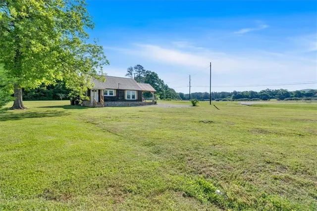 a view of a large garden with an buildings in the background