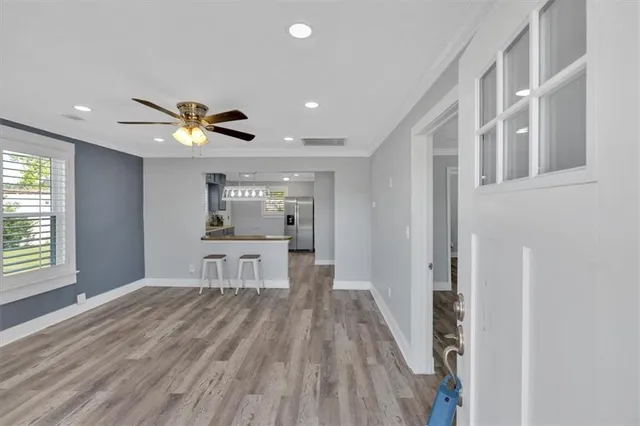 a view of a livingroom with furniture wooden floor and a window