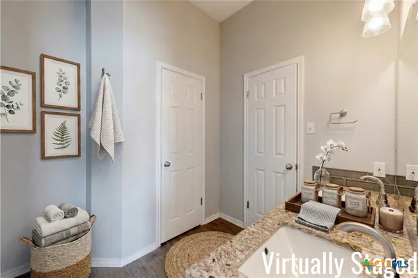 a bedroom with furniture and a wooden floor